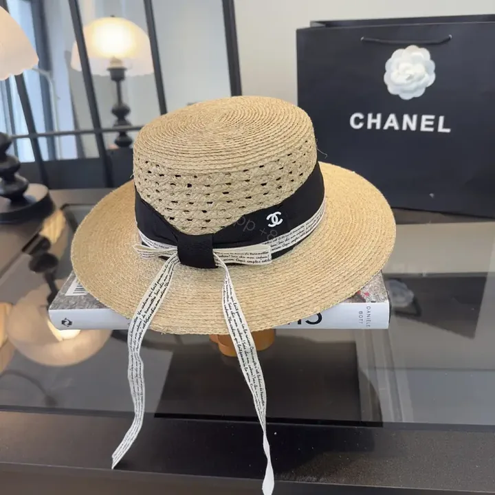 View 1 of Natural Straw Fedora Hat with Bow Ribbon Detail - Chanel Logo