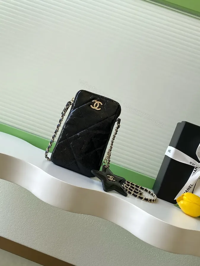 View 1 of Black Quilted Crossbody Bag with Gold Chain