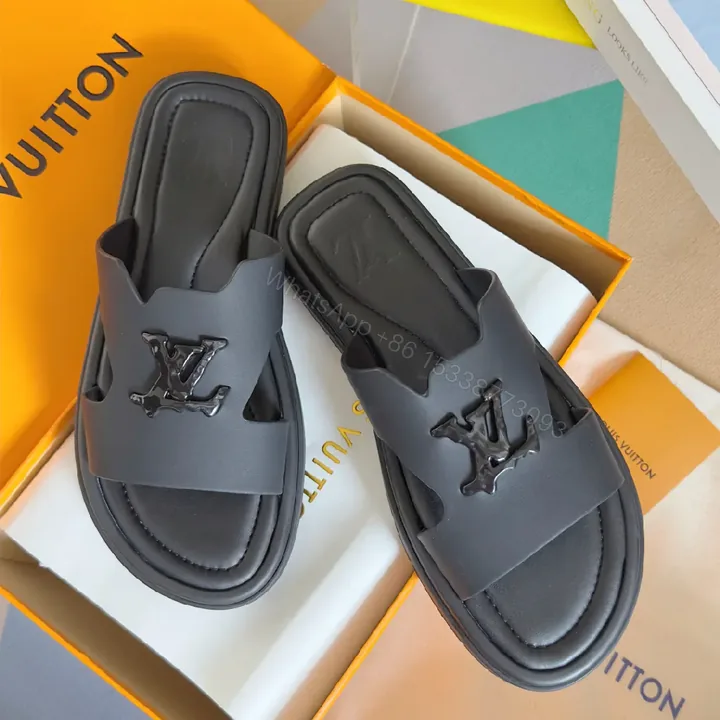 View 1 of Minimalist Black Leather Slides with Signature Emblem