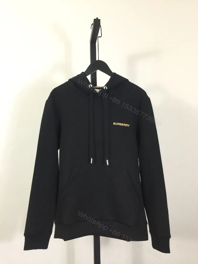 View 1 of Minimalist Black Hoodie with Gold Logo – Premium Casual Wear