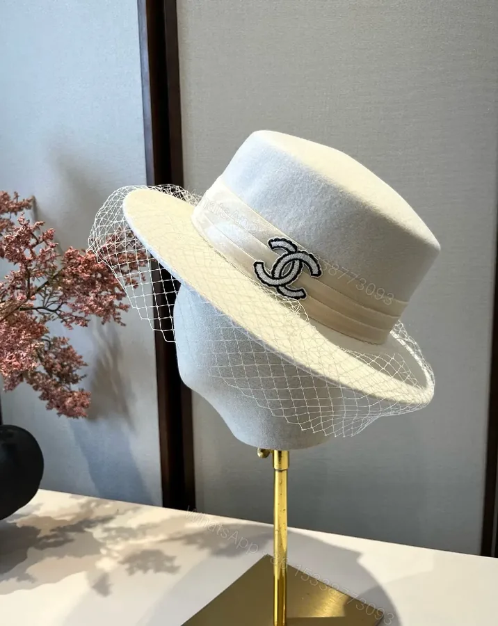 View 1 of Ivory Felt Fedora with Veil & Emblem Accent