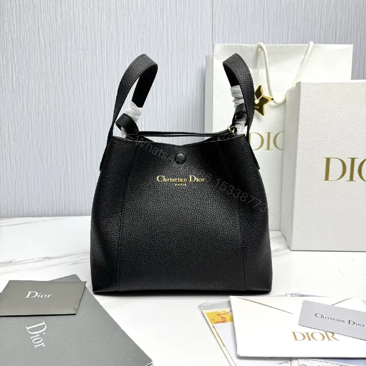 View 1 of Compact Black Pebbled Bucket Bag - Structured Luxury Everyday