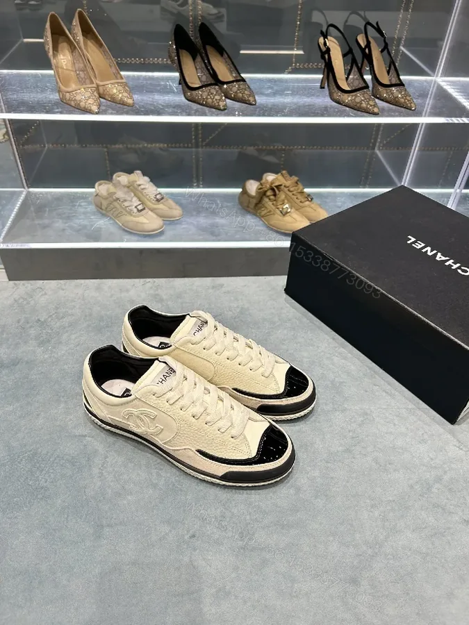 View 1 of Cream Leather Sneaker + Subtle Chanel-Inspired Detail + High-Top Comfort + Timeless Glossy Toe + Sneaker