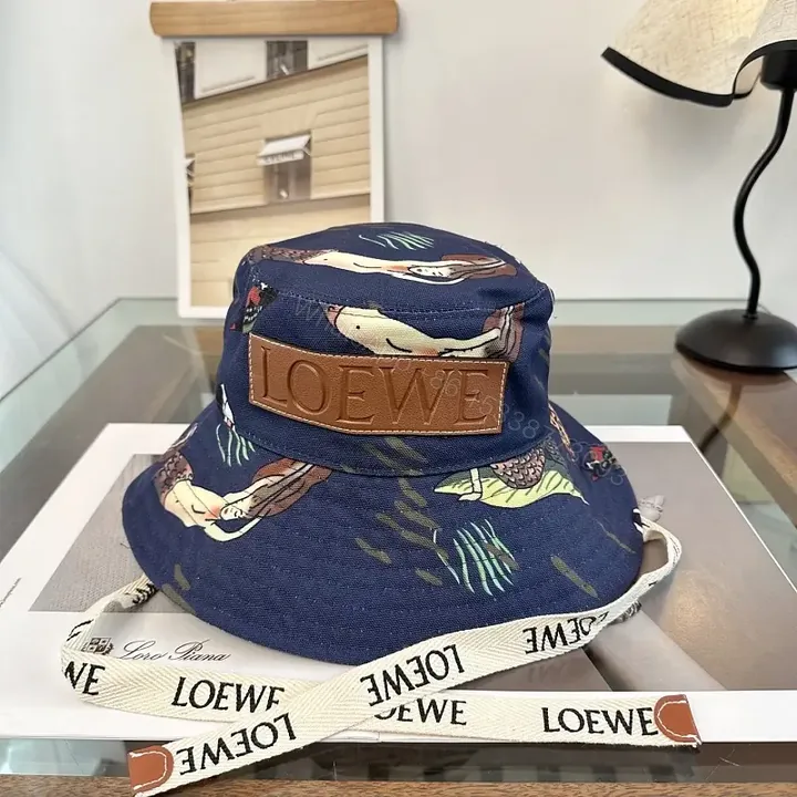 View 1 of Navy Floral Canvas Bucket Hat with Leather Brand Patch