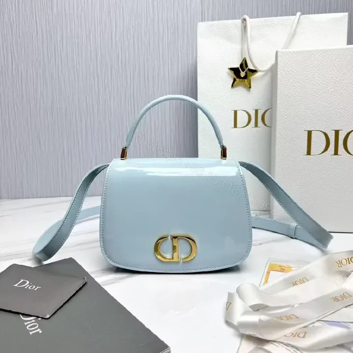 View 1 of Soft Sky Blue Mini Bag with Gold Hardware Logo Accent Bag