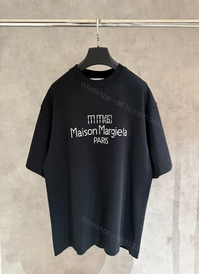 View 1 of Oversized Black Tee with Subtle Dot Logo — Luxe Everyday Wear
