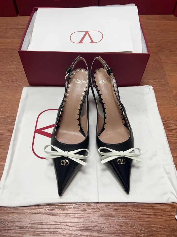 View 1 of Valentino Women Black Patent Leather Bow Slingback Pumps