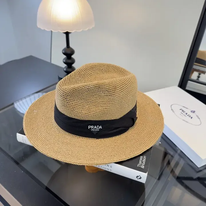 View 1 of Light Tan Straw Wide-Brimmed Floppy Hat with Black Ribbon Band
