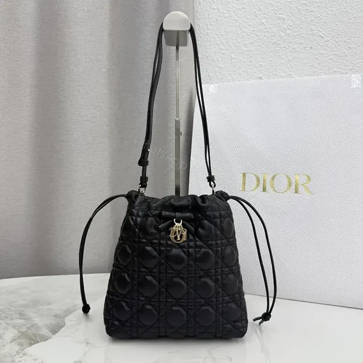 View 1 of Quilted Black Drawstring Bucket Bag with Gold Hardware