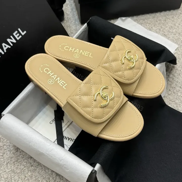 View 1 of Beige Quilted Leather Sliders with Gold Logo—Elegant Comfort
