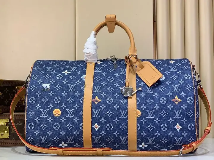 View 1 of Blue denim monogram-print travel bag with tan leather trim for luxury weekends