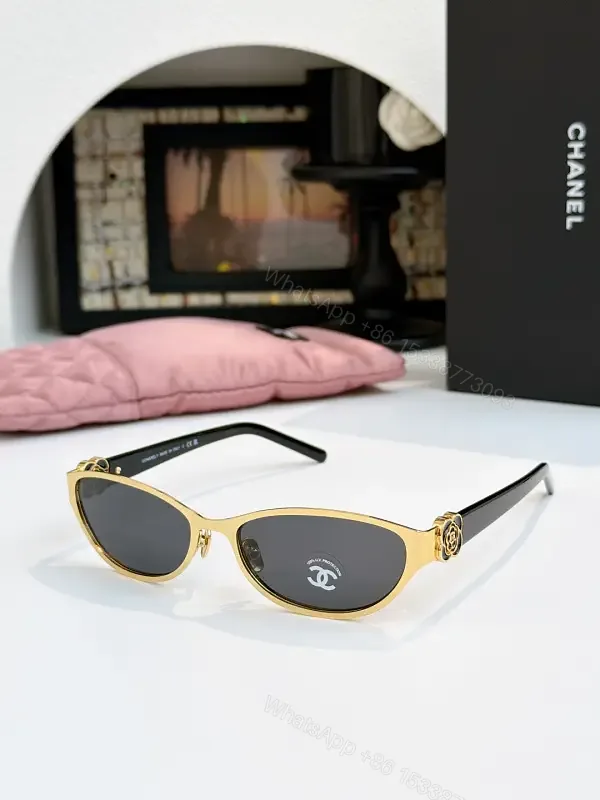 View 1 of Gold Cat-Eye Sunglasses with Chanel Logo Accents