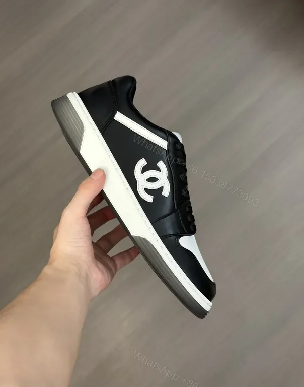 View 1 of Monochrome Chanel-Style Low-Top Sneakers with Signature Emblem