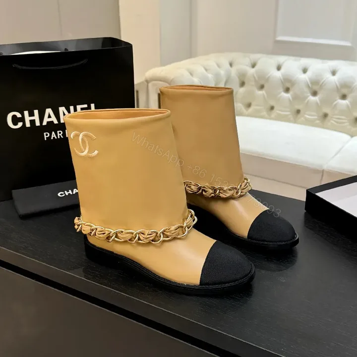 View 1 of Chic Tan Leather Boots with Black Toe Cap and Chain Detail