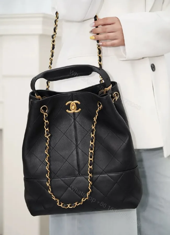 View 1 of Black Quilted Bucket Bag with Gold Chain Strap