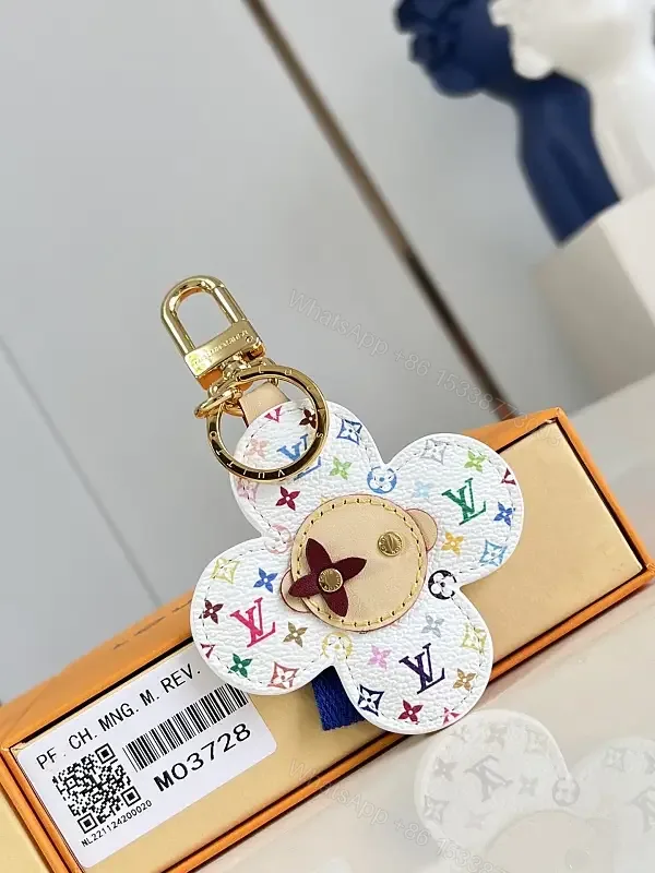 View 1 of White Leather-like Quilted Flower Keychain - LV Monogram Accent, Gold Hardware