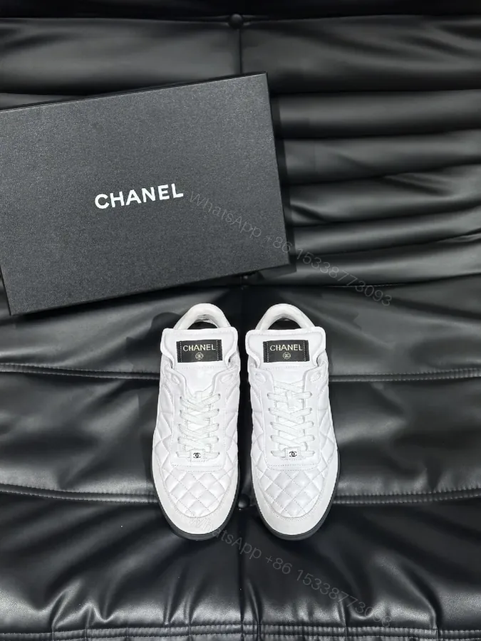 View 1 of White Quilted Low-Top Sneakers with Chanel-Inspired Detail
