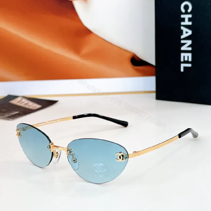 View 1 of Rimless Blue Lens Sunglasses with Gold-Tone Frames