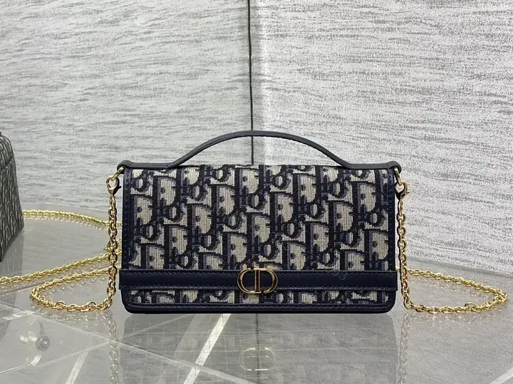 View 1 of Navy monogram canvas leather-trim shoulder bag for everyday luxury
