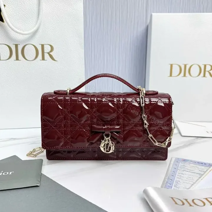 View 1 of Glossy Burgundy Quilted Mini Bag with Bow Accent