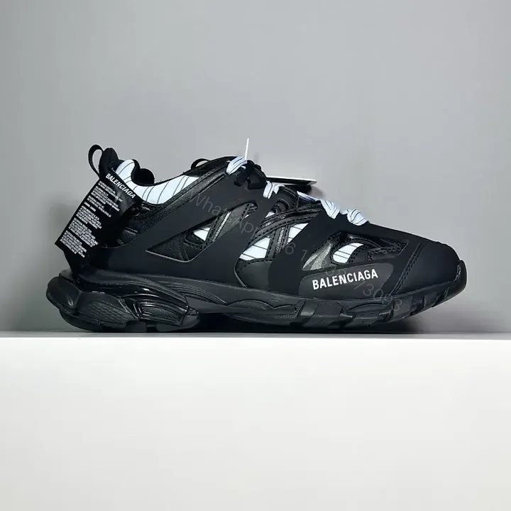 View 1 of black leather and mesh sneakers with logo motif for luxury streetwear