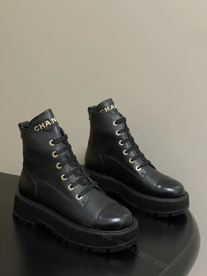 View 1 of Black Leather Combat Boots with Gold Branding Feature