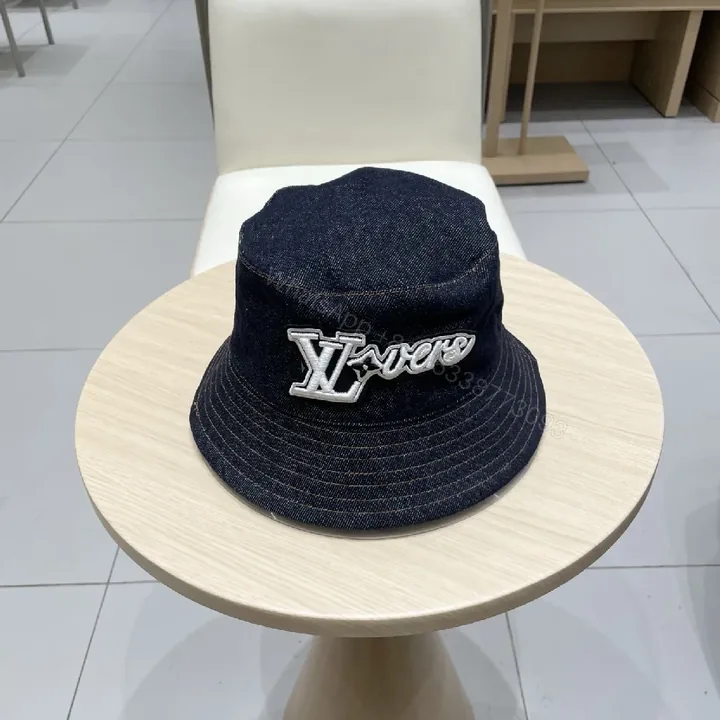 View 1 of Denim Bucket Hat + Embroidered Logo + Streetwear Chic + Luxury Detail + Hat