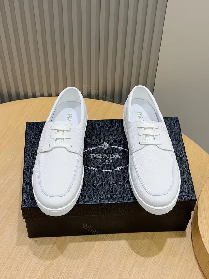 View 1 of Minimalist White Leather Low-Top Sneakers with Subtle Luxury Details
