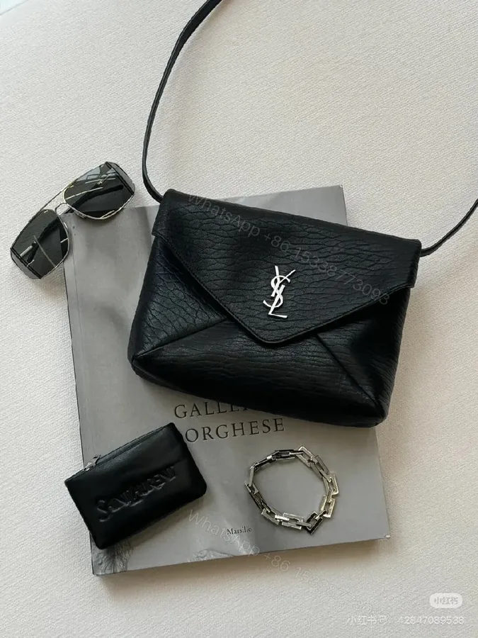 View 1 of Black Textured Leather Envelope Bag – Minimal Logo, Compact & Versatile