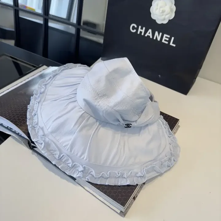 View 1 of Pastel Blue Floppy Hat with Ruffled Brim & Chanel Charm