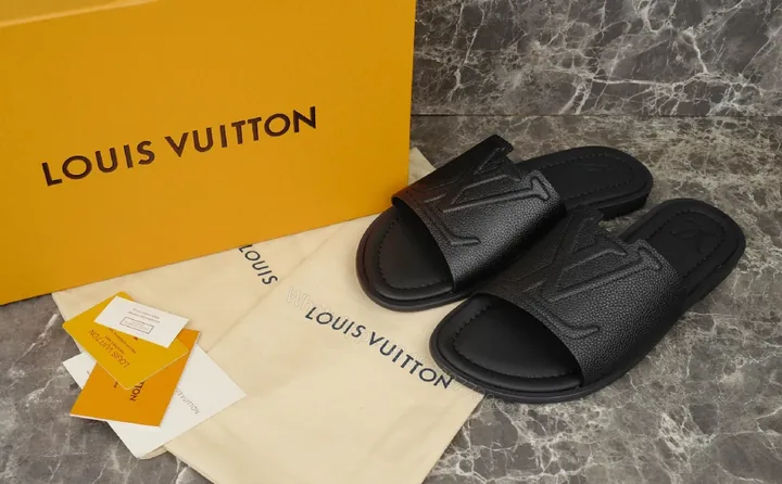 View 1 of Bold Leather Slides with Monogram Texture – Everyday Luxury