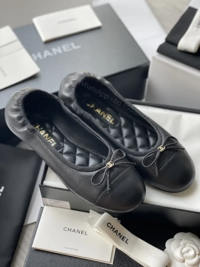View 1 of Quilted Black Flats with Gold Logo Accents - Chic Comfort