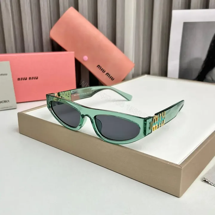View 1 of Miu Miu Cat Eye Green-Black Sunglasses One Size
