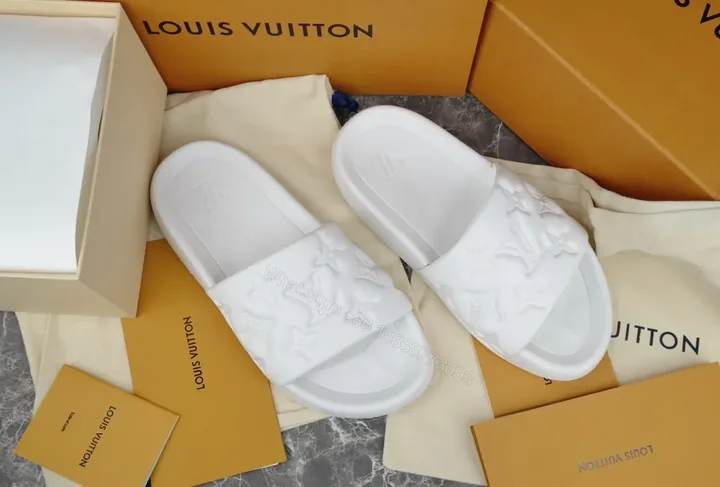 View 1 of Minimalist White Slides with LV Embellishment â€“ Luxe Comfort Slide
