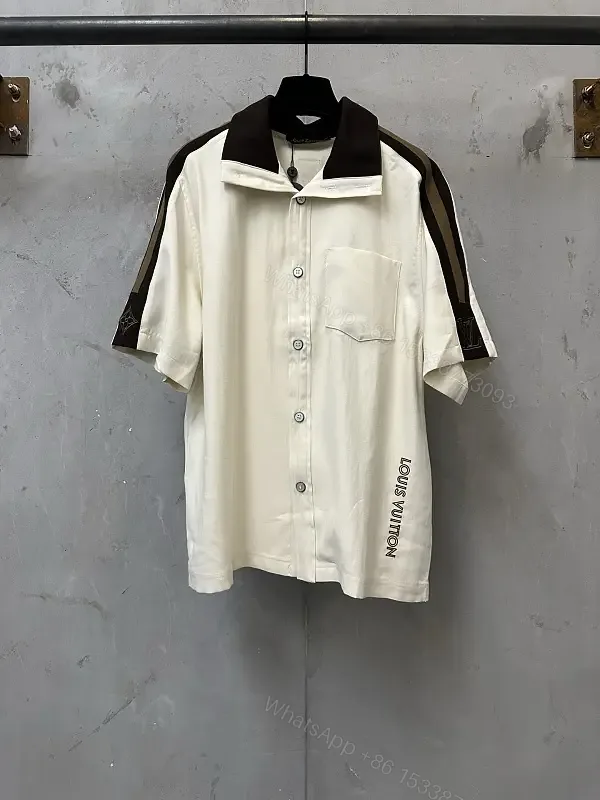 View 1 of White Cotton Polo Shirt with Black Accent Louis Vuitton Style Key Feature Pocket Short Sleeve Shirt