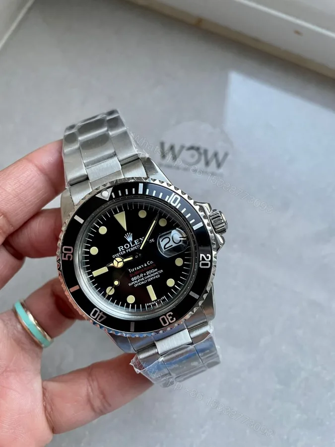 View 1 of VINTAGE Rolex Submariner Date Tiffany & Co 16610A30B9315 Black dial with SS bracelet