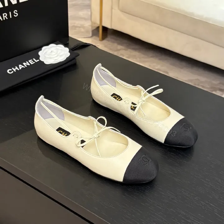 View 1 of Ivory Leather Ballet Flats with Black Cap Toe, Lace-Up, Elegant