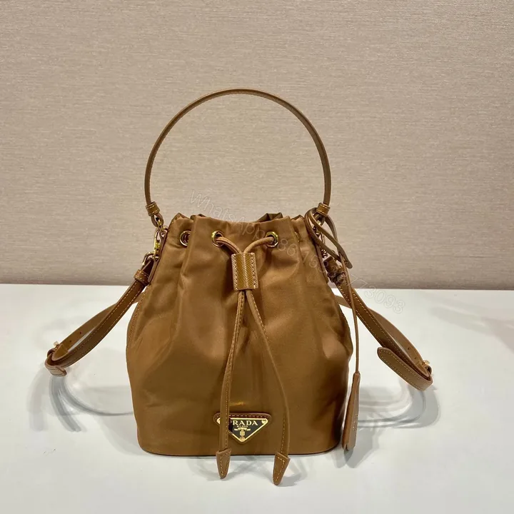 View 1 of BUCKET BAG 19 IN RUSSET BROWN RE-NYLON AND CALFSKIN HANDLE