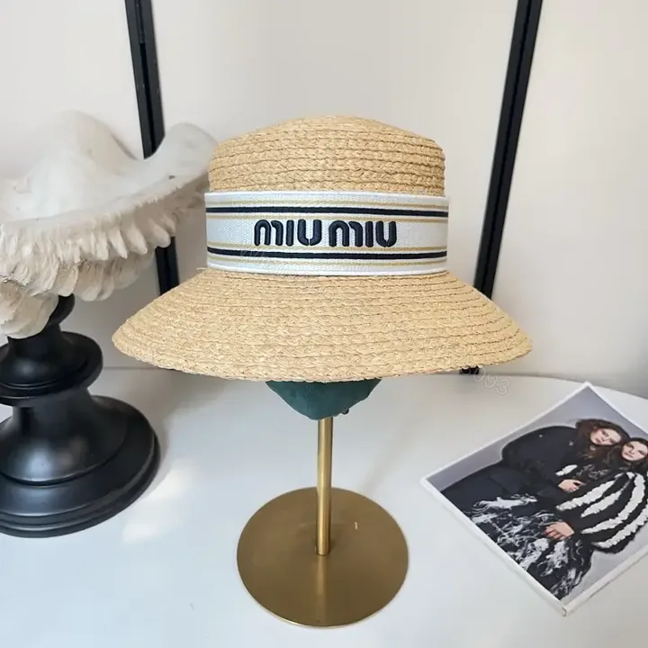 View 1 of Light Tan Straw Hat Wide Brim Flat Crown White Band Blue Stripes MIU MIU Visor Hat