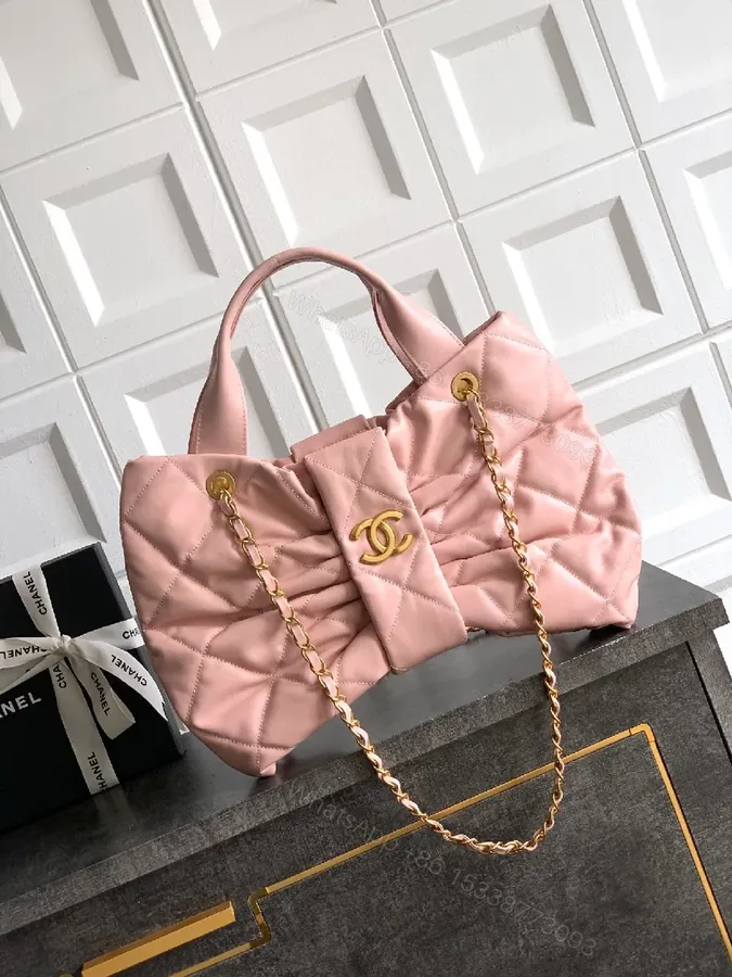 View 1 of Soft Pink Quilted Handbag with Gold Accents, Compact Luxury Tote