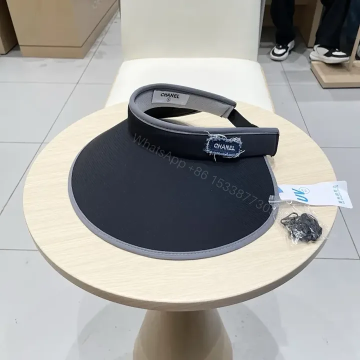 View 1 of Minimalist Black Visor with Chanel-Inspired Detail, UV Shield