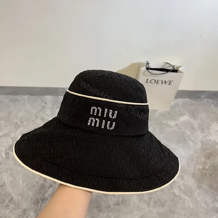 View 1 of Structured Black Straw Bucket Hat — Crystal Logo Accent, All-Season Style