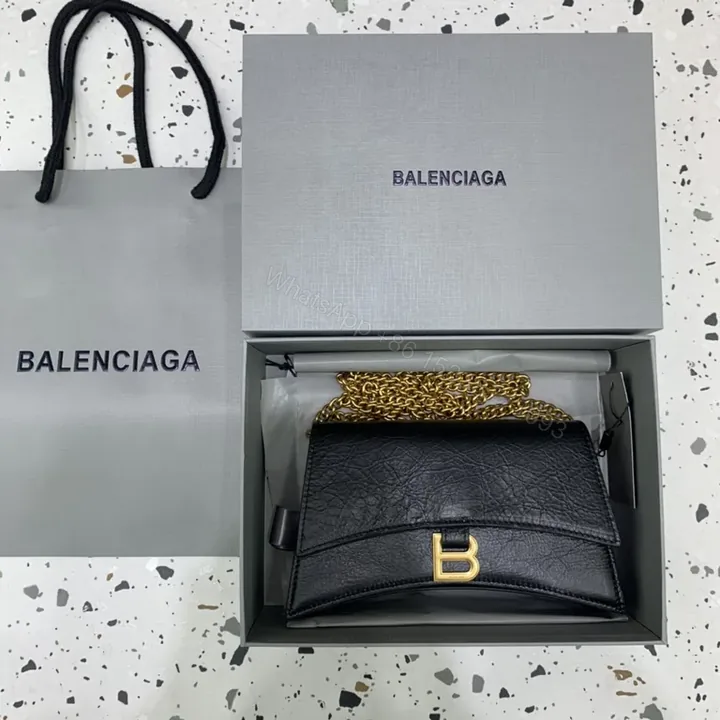 View 1 of Chic Black Leather Mini Bag with Gold B Clasp â€“ Compact Luxury