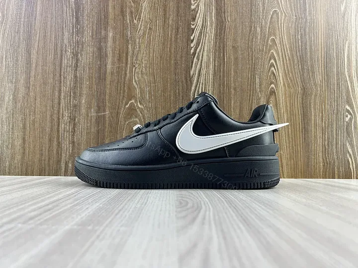 View 1 of Black Leather Low-Top Sneakers with White Swoosh - Luxury Streetwear