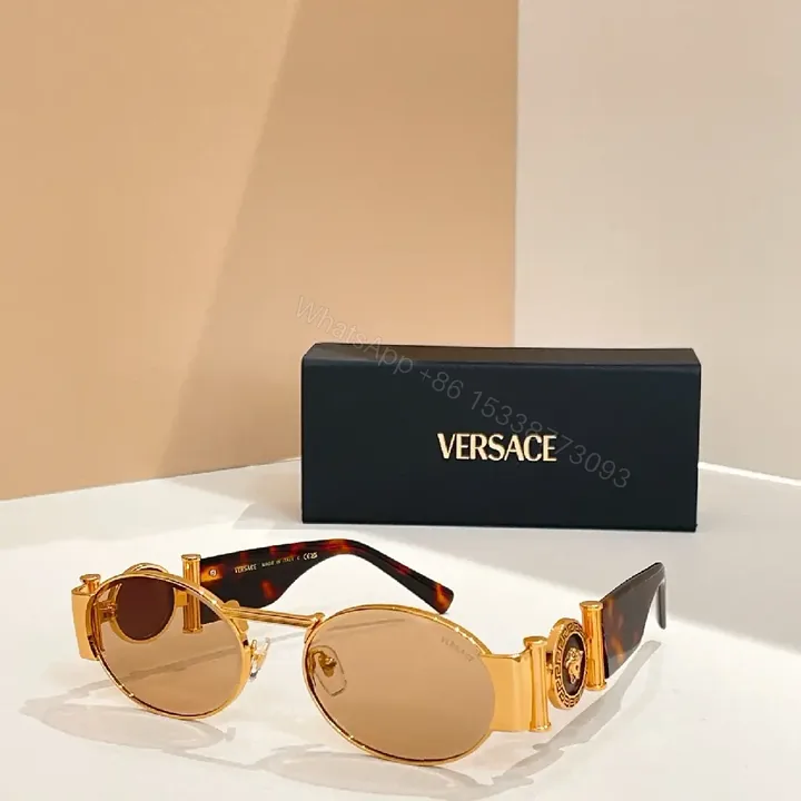 View 1 of Amber-Tinted Round Sunglasses: Gold-Accent, Sculpted Hardware, UV400 Shield