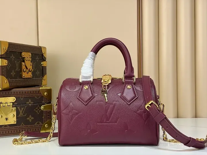 View 1 of Deep Plum Leather Satchel: Structured Top-Handle Bag with Embossed LV Motifs
