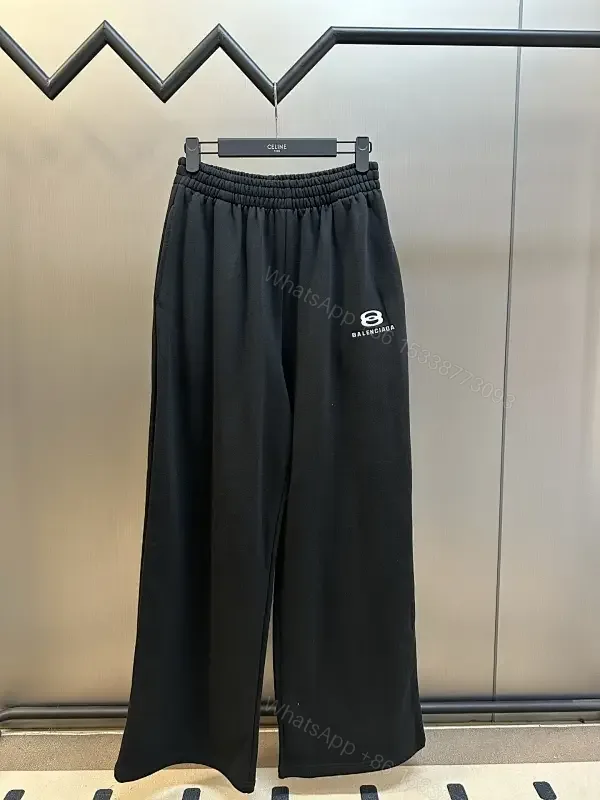 View 1 of Chic Black Wide-Leg Track Pants with Subtle Logo