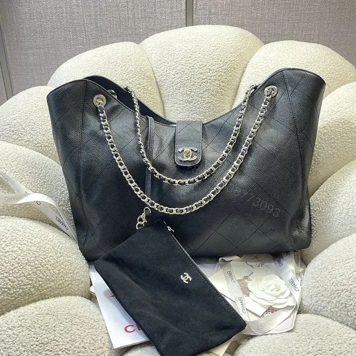View 1 of Black Quilted Leather Shoulder Bag with Chain Straps and Chanel Logo
