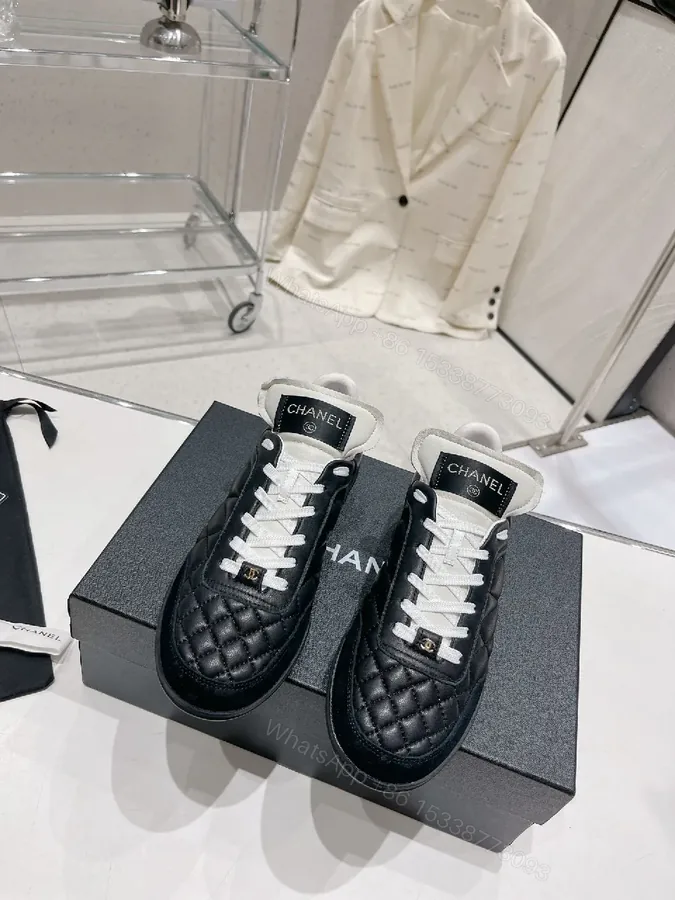 View 1 of Quilted Black Leather Sneakers with Luxe Branding Detail