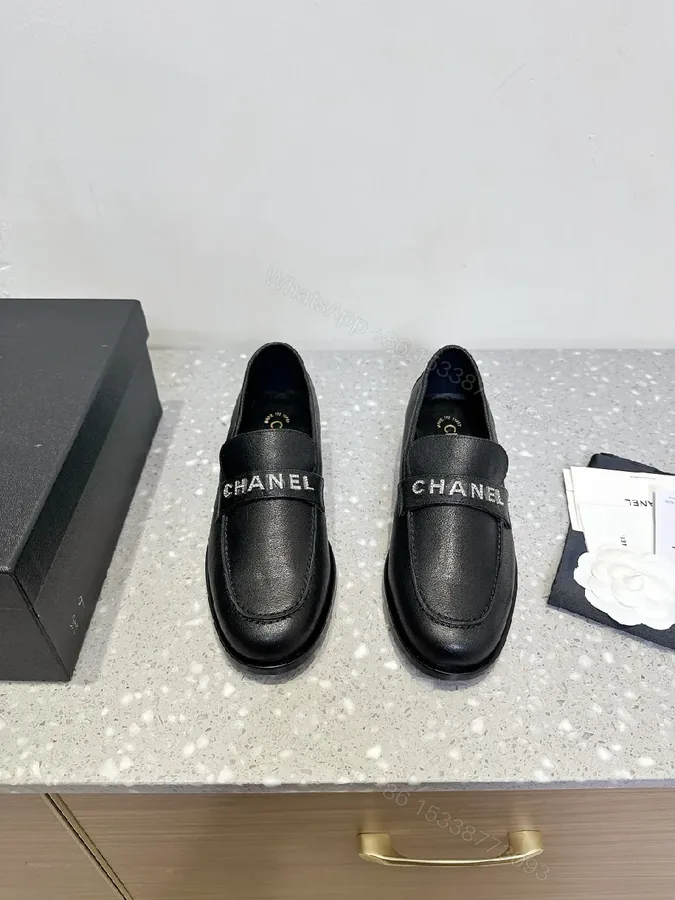 View 1 of Black Leather Slip-On with Logo Strap – Modern Luxe Comfort